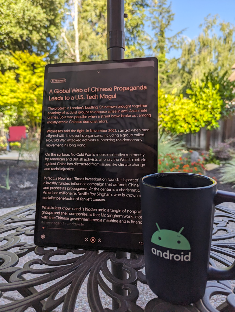 Tablet with text in Android Reading mode. An Android mug is next to it.